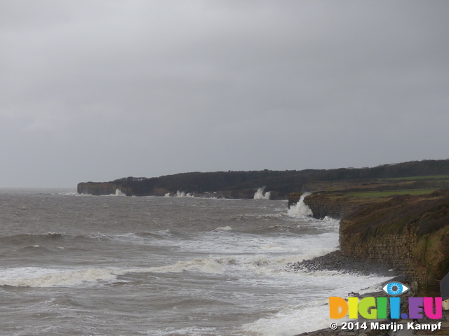 LZ00617 Waves crashing against cliffs at Llantwit Major beach